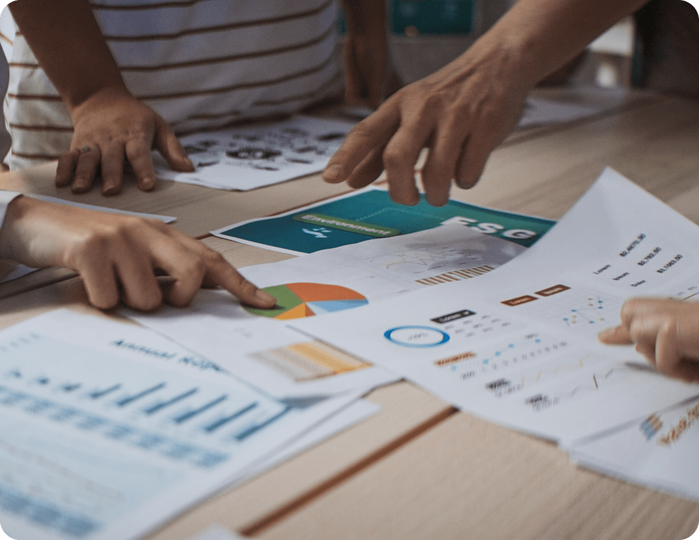 Hands pointing at business charts